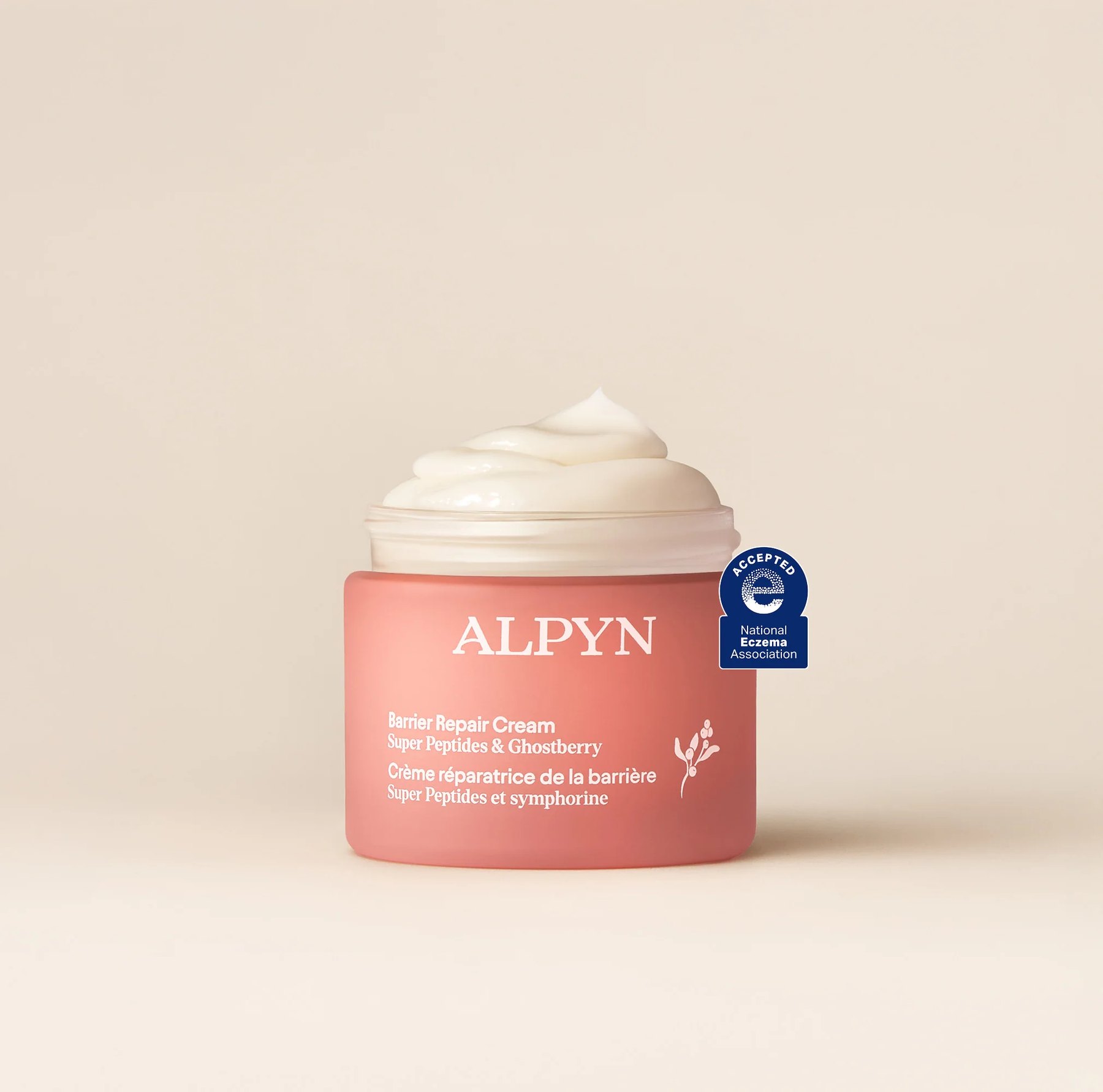 Open jar of Alpyn Barrier Repair Cream showing thick white texture.