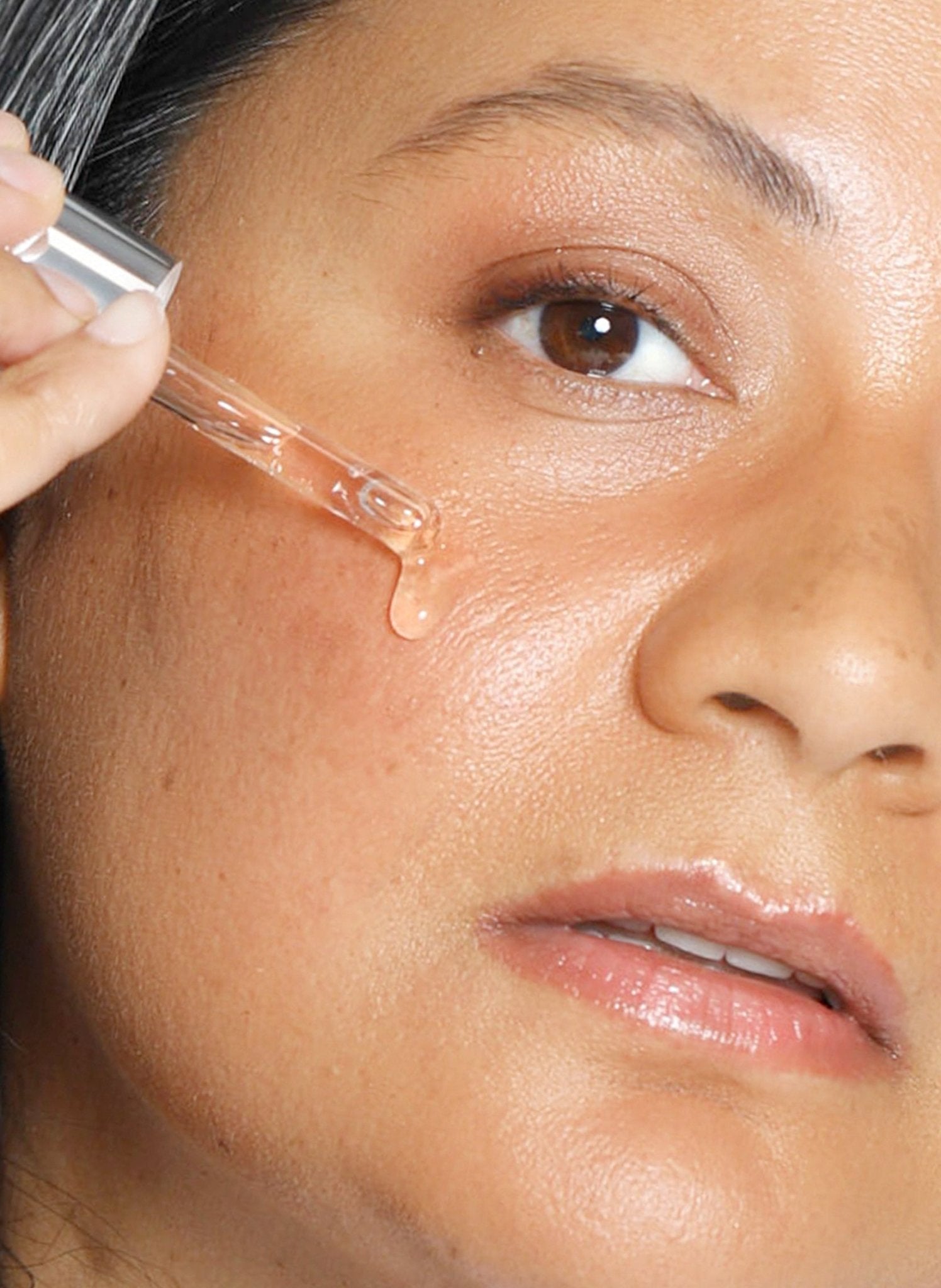Theorem Serum Boost applied across the face.