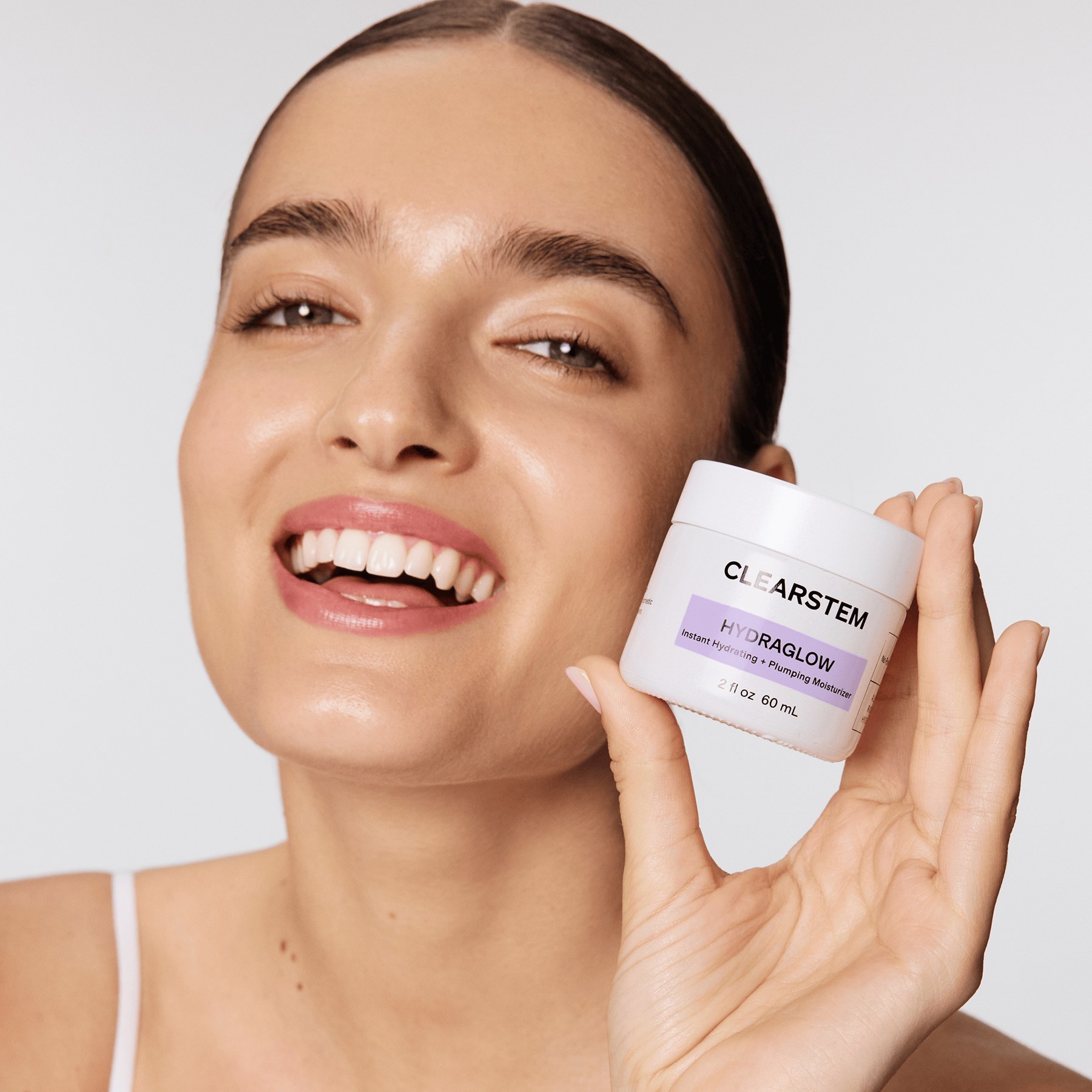 A model presenting HYDRAGLOW Plant Stem Cell Moisturizer, described as the top selling skincare item.